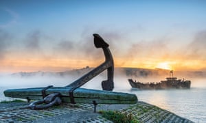 Mist drifts down the River Torridge estuary, passing the famous Appledore Anchor in North Devon, near the Appledore shipyard.