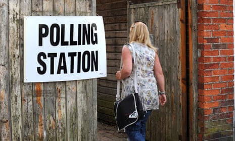 A woman walks into a polling station to vote