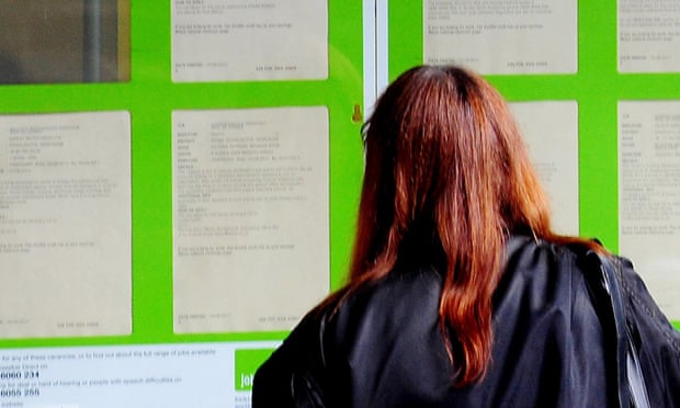 A woman looks at vacancies at a job centre.