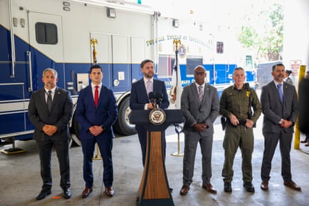 JD Vance speaks into a microphone as five men flank him on boths dies.