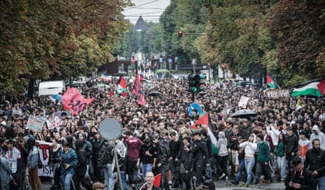 People march during a nationwide strike in solidarity with Palestinian people in Gaza and call for a halt to arms shipments to Israel during a rally in Turin.