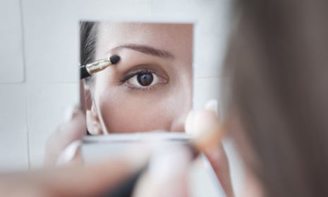 Woman does make-up in a mirror