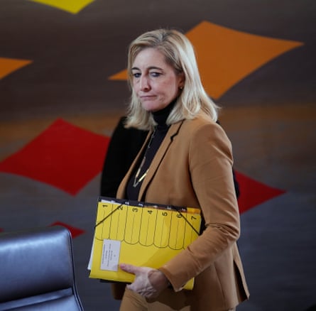 Nina Warken carrying a folder.