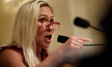 a woman points while speaking into a microphone a woman points while speaking into a microphone