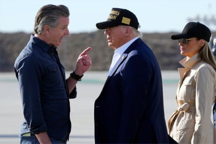 a man pointing his finger at another man and a women