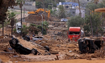 Damaged vehicles lie in mud in Derna