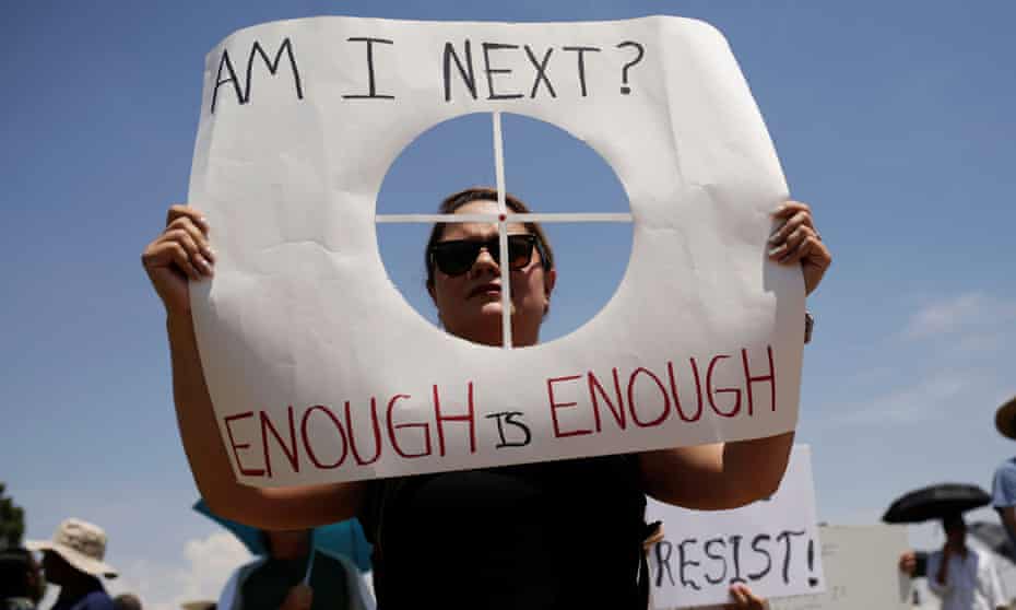 A woman holds a placard bearing the likeness of a shooting target during a rally against the visit of U.S. President Donald Trump after last weekend’s shooting at a Walmart store, in El Paso, Texas, U.S., August 7, 2019.