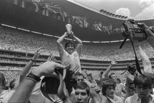 Argentina’s Diego Maradona celebrates holding the World Cup trophy aloft as he is carried off the field after Argentina won the World Cup Final between Argentina and West Germany at the Estadio Azteca in Mexico City, Mexico 29 June, 1986