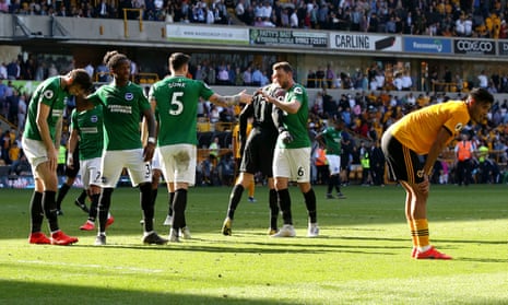 Brighton players celebrate after holding on for a point at Molineux.