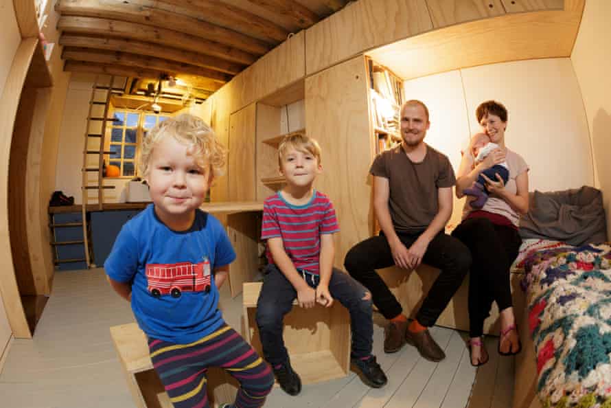 Tom, James, five, Tim Francis, Laura Hubbard-Miles and Edith (eight weeks) in their home’s main living area.