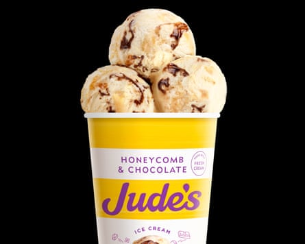 A yellow and white tub of Jude's Honeycomb & chocolate ice-cream topped with three ice-cream balls