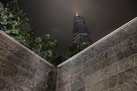 The Freedom Tower rises above one of the 9/11 Memorial reflecting pools