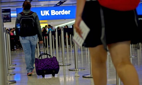 Passengers walking towards border control at Heathrow airport