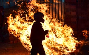 A man walks past a burning blockade in Sacaba, Bolivia