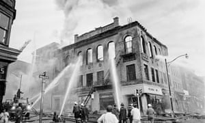 Newark firemen play steady streams of water on a gutted structure at Court and Prince Streets in Newark.