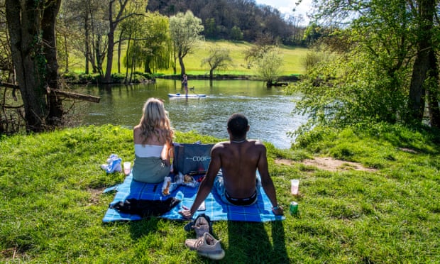 Two people chilling with a picnic next to the river at Goring.