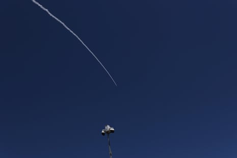 A white line in a clear sky from a projectile being intercepted.