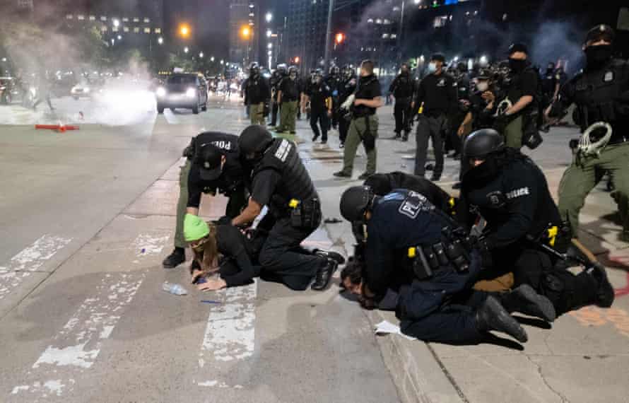 Officers arrest a protester near the police station in Detroit, Michigan, on 30 May 2020.