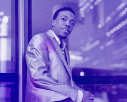 A purple-hued portrait of Peven Everett wearing a suit jacket and shirt