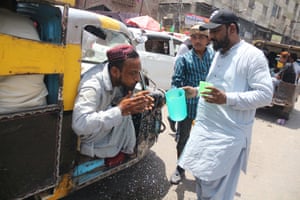 People drink free juice on the roadside in Hyderabad, Pakistan