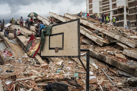 A basketball backboard surrounded by rubble