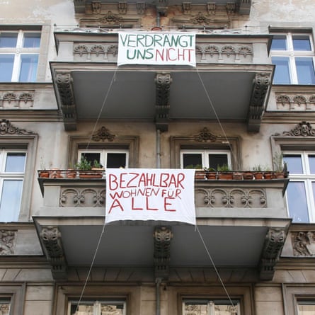 Homemade banners suspended from apartment building balconies