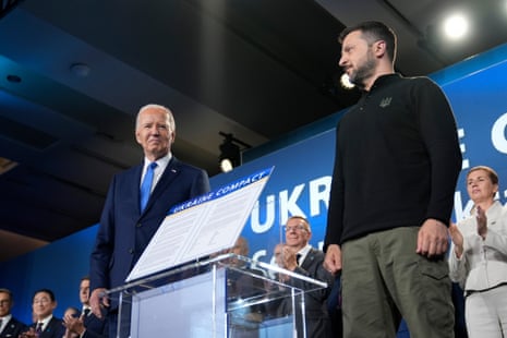 President Joe Biden, left, and President of Ukraine Volodymyr Zelenskiy pose flanking the Ukraine Compact during an event on the sidelines of the Nato Summit in Washington.