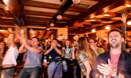 Kosovans celebrate Xhaka’s goal as they watch the match in a pub in Pristina.