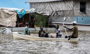 People row through a flooded area in Boma state, South Sudan. At least 76 people have died and over 400,000 people have been displaced since flooding began last month.