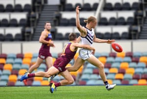 Hayden Young of the Dockers is tackled by Lincoln McCarthy of the Lions.