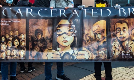 People hold a banner in a human chain in Kingston, London, to protest against political oppression in Hong Kong, January 2022.