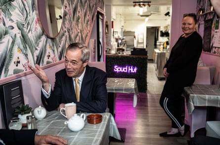 Nigel Farage in a cafe campaigning and meeting supporters