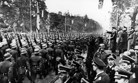 The rising storm: German troops parade in front of Hitler and his Nazi generals after entering Warsaw on 5 October 1939.