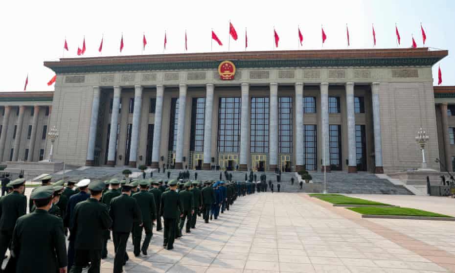 Soldiers and armed police walk into the Great Hall of the People in Beijing.