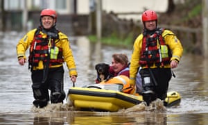 A member of the public and their dog are rescued after flooding in Nantgarw, Wales.