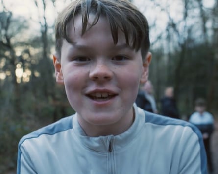 Mason in the woods smiling at camera