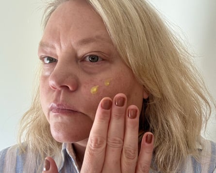 The writer tests a cream on her face.
