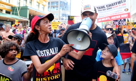NRL player Latrell Mitchell ensures his voice can be heard during the Invasion Day rally in Sydney