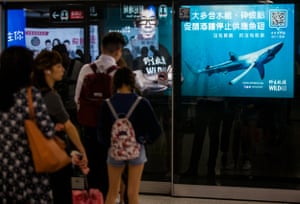 A billboard on a HongKong subway platform features Chinese movie and TV celebrity Bowie Wu-fung calling on restaurants in the city to stop selling shark fin