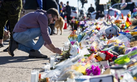 People place flowers at a memorial outside of Club Q in Colorado Springs, Colorado.