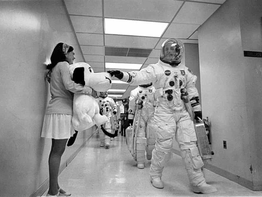 Headed for the launch pad, Apollo 10 Commander Tom Stafford pats the nose of a stuffed Snoopy held by Jamye Flowers (Coplin), astronaut Gordon Cooper’s secretary.