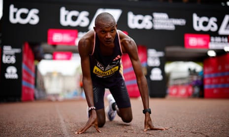 Alexander Munyao crosses the finish line to win the elite men’s race