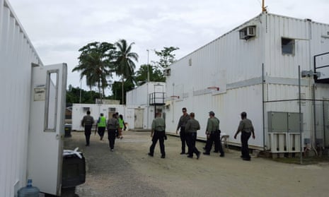 Authorities inside the Manus Island detention centre walking around the camp in February.