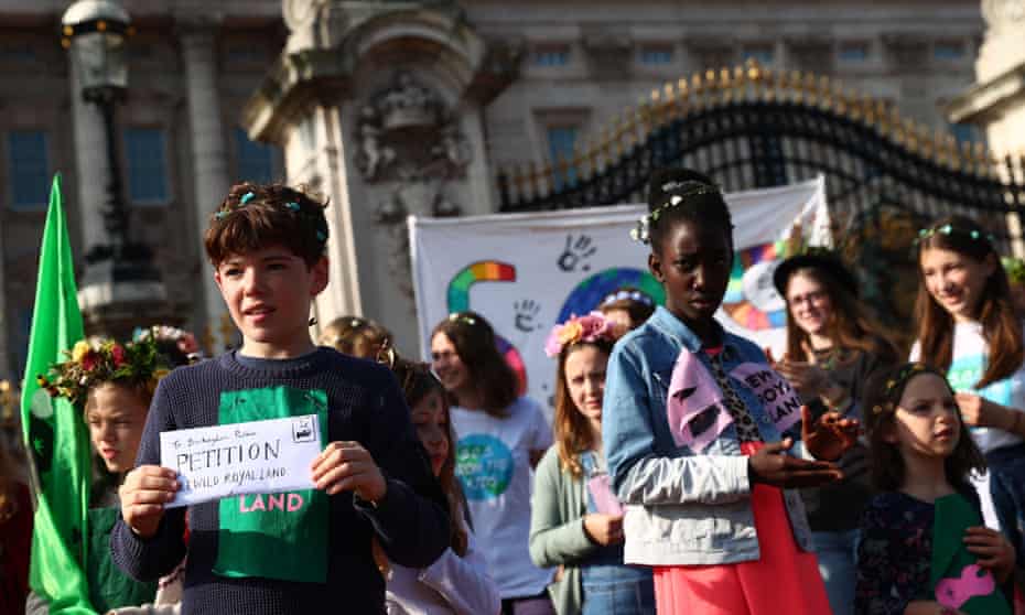 Fourteen-year-old Simeon Macaulay and other schoolchildren at a protest outside Buckingham Palace urging the Royal Family to rewild their land.