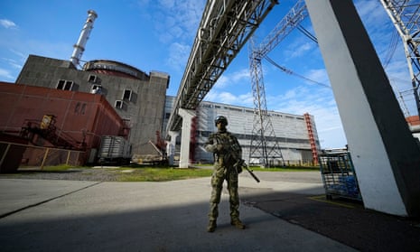 A Russian serviceman stands guard at the Zaporizhzhia plant