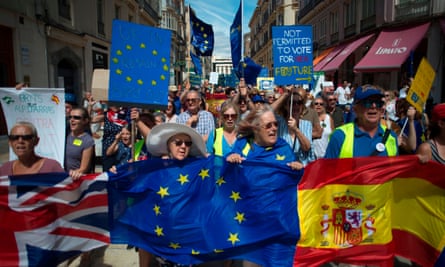 British people and others wave EU and Spanish flags as they protest against Brexit in Malaga in September 2019