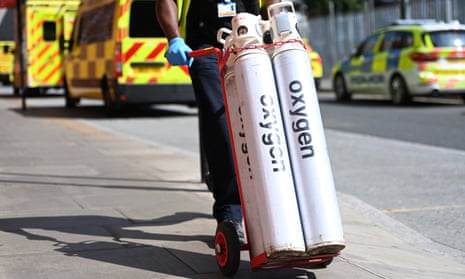 Hospital staff move oxygen tanks outside the Royal London hospital last Friday.