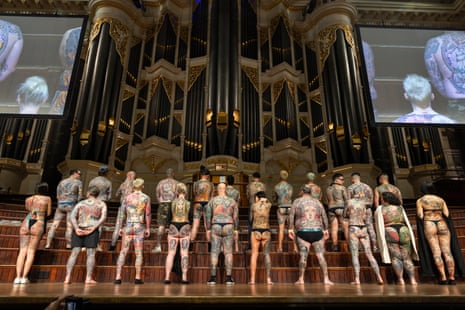 Tattooed attenders stand on stage before judging kicks off for day two’s competition