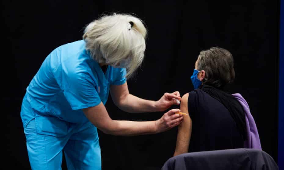 A woman receives a Covid vaccine in Newcastle upon Tyne