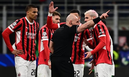 TOPSHOT-FBL-EUR-C1-MILAN-FEYENOORD<br>TOPSHOT - Polish referee Szymon Marciniak gives a red card to AC Milan's French defender #19 Theo Hernandez (R) during the UEFA Champions League knockout round play-off second leg football match between AC Milan and Feyenoord at San Siro stadium in Milan, on February 18, 2025. (Photo by Piero CRUCIATTI / AFP) (Photo by PIERO CRUCIATTI/AFP via Getty Images)